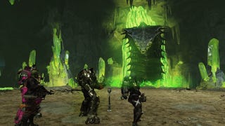Four Vault dwellers in power armour approach the Ultracite Terror, a large snake that's emerging from a green, irradiated pool, in Fallout 76.